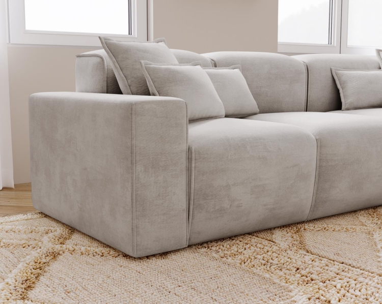 Tapicerowany jasny narożnik w szarym kolorze do dużego salonu AURIA